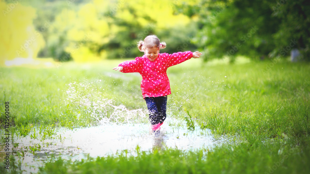 雨后快乐的小女孩在水坑里奔跑跳跃