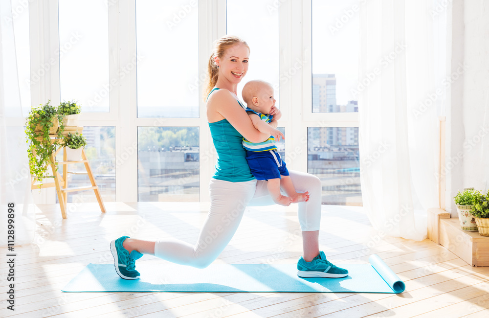 sports mother is engaged in fitness and yoga with baby at home
