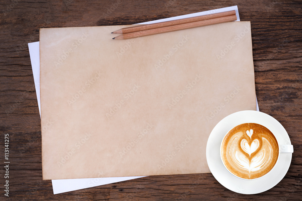 blank paper with pencil and a cup of coffee on wooden