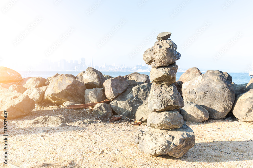 rock pile on shore of sea in san francisco in blue sky