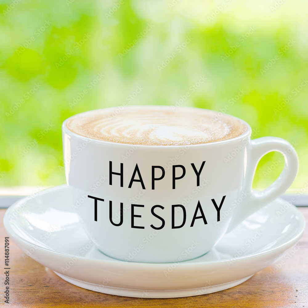 Happy Tuesday on coffee cup over natural background