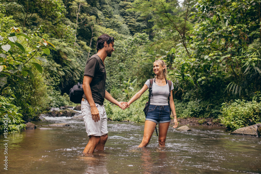 Loving young couple in forest stream