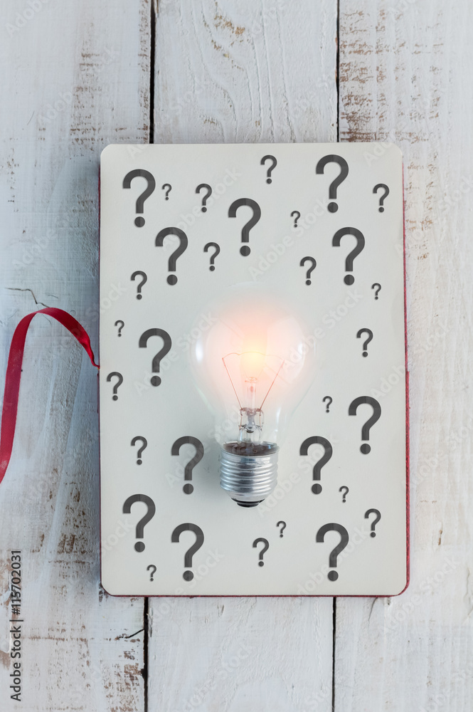 Light bulbs with notebook and question mark symbol.jpg