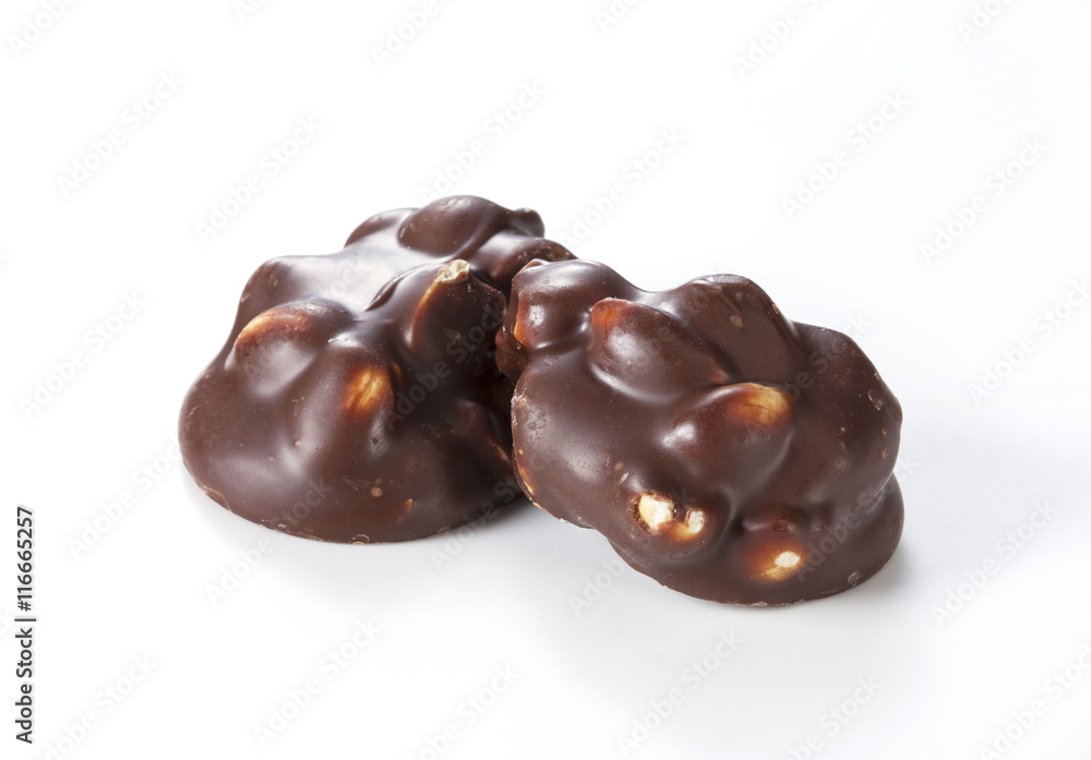 Chocolate pieces with nuts on a white background