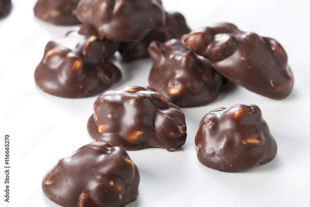 Chocolate pieces with nuts on a white background