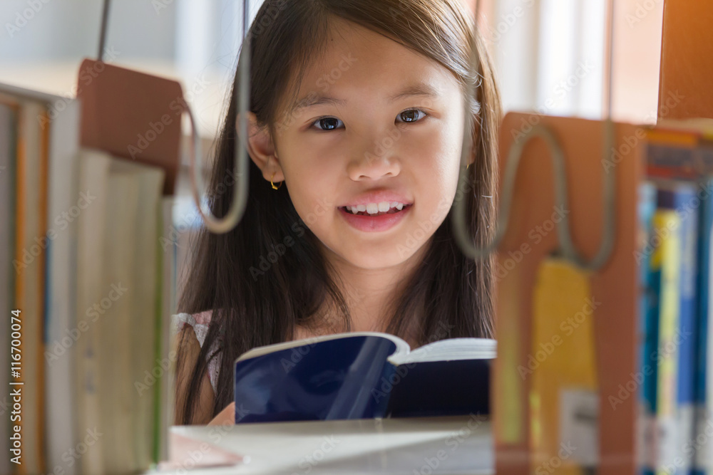 亚洲小女孩在学校图书馆看书