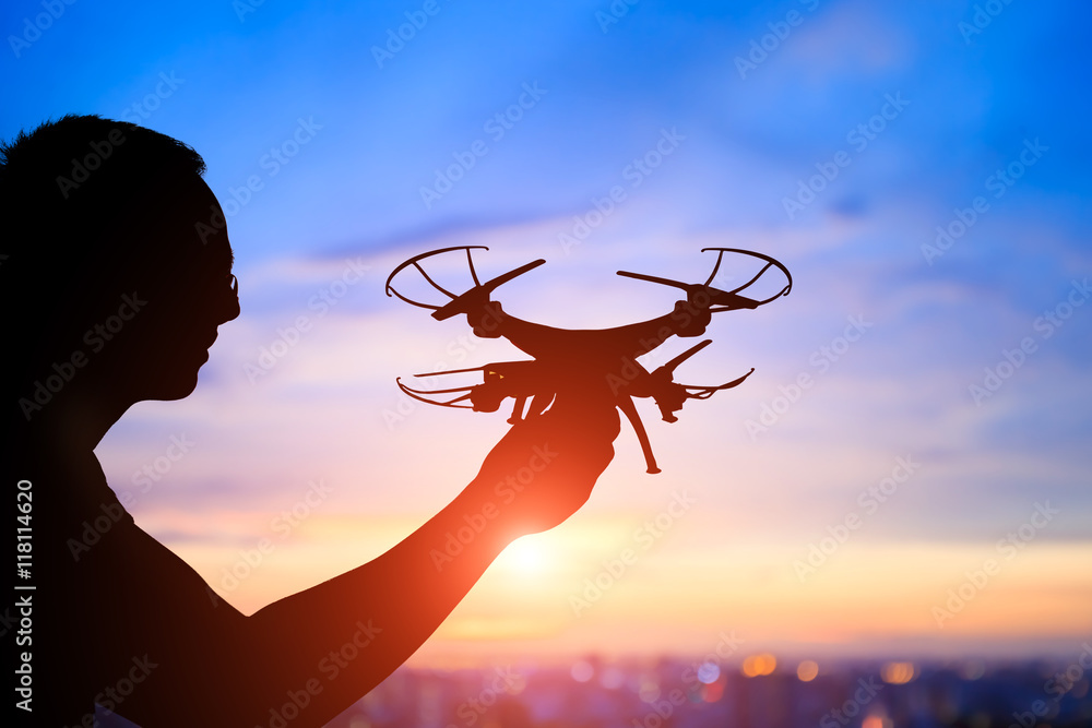 silhouette of man take drone
