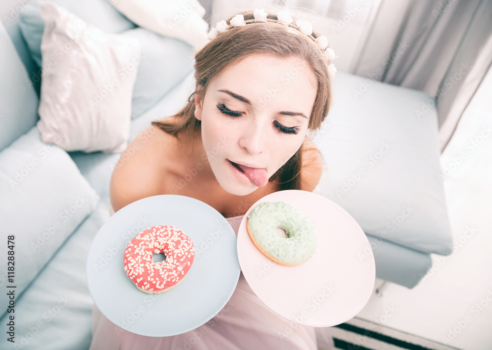 Woman look like princess at home with two donuts