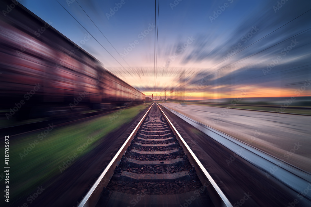 日落时货运车厢在运动的火车站。具有运动模糊效果的铁路。铁路平面图