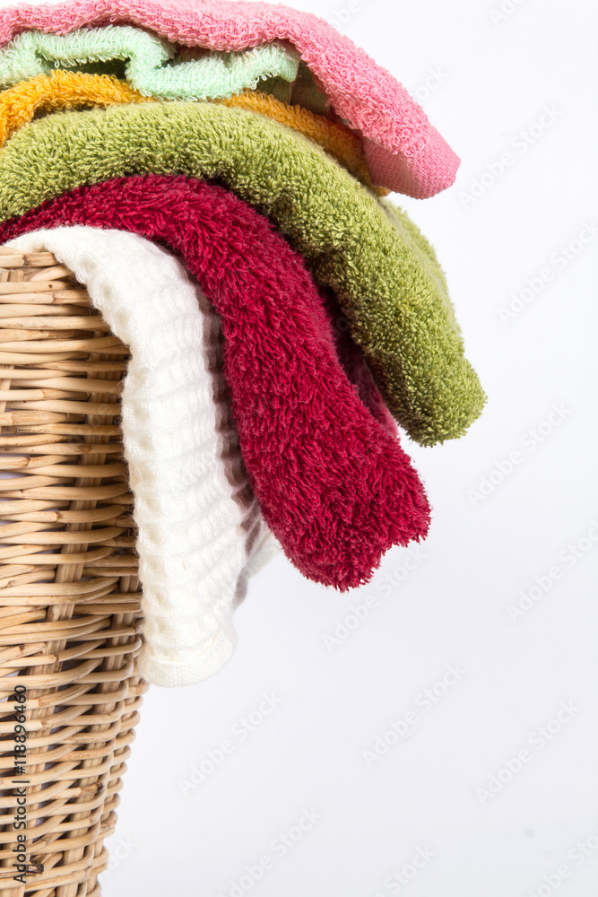 close up color mix  towel in wicker baskets on white background