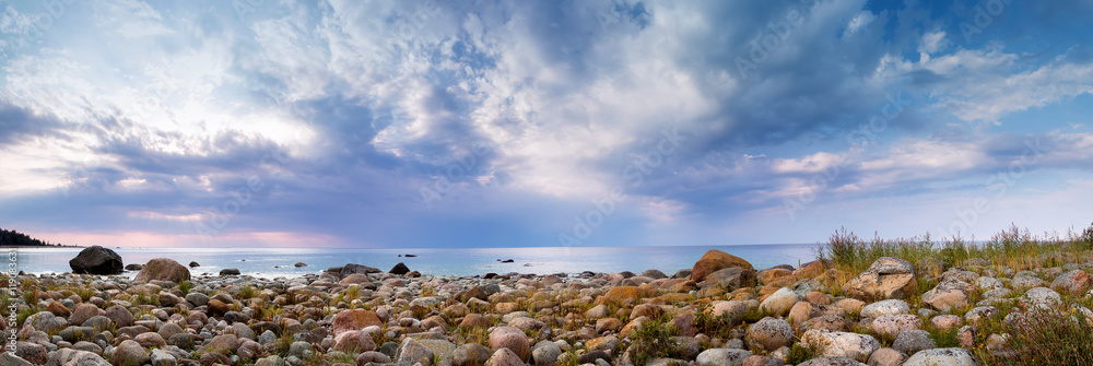Rocky shores at the sea in sunset light. Lahemaa natural park coastal landscape with beautiful sky