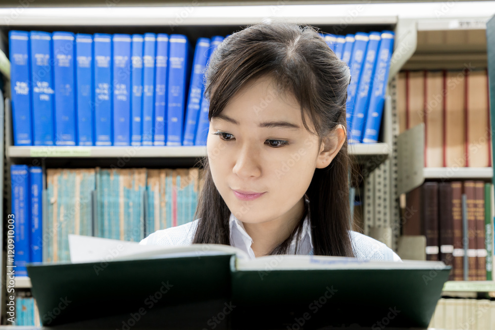 亚洲高中生在大学图书馆阅读。