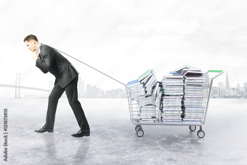 Man dragging trolley with books