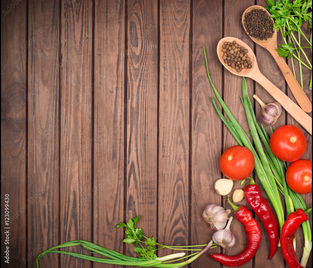 wood background with spices and vegetables