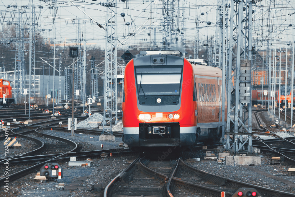 德国纽伦堡日落时分的火车站，有现代化的红色通勤列车。带vintag的铁路