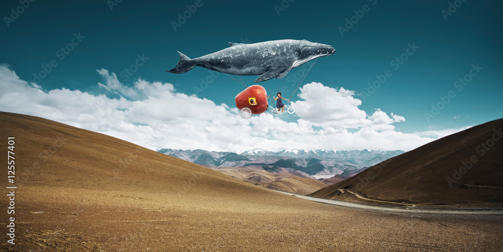 Travel concept. Whale floats in the sky and carrying a happy sister  with fantasy apple bike .