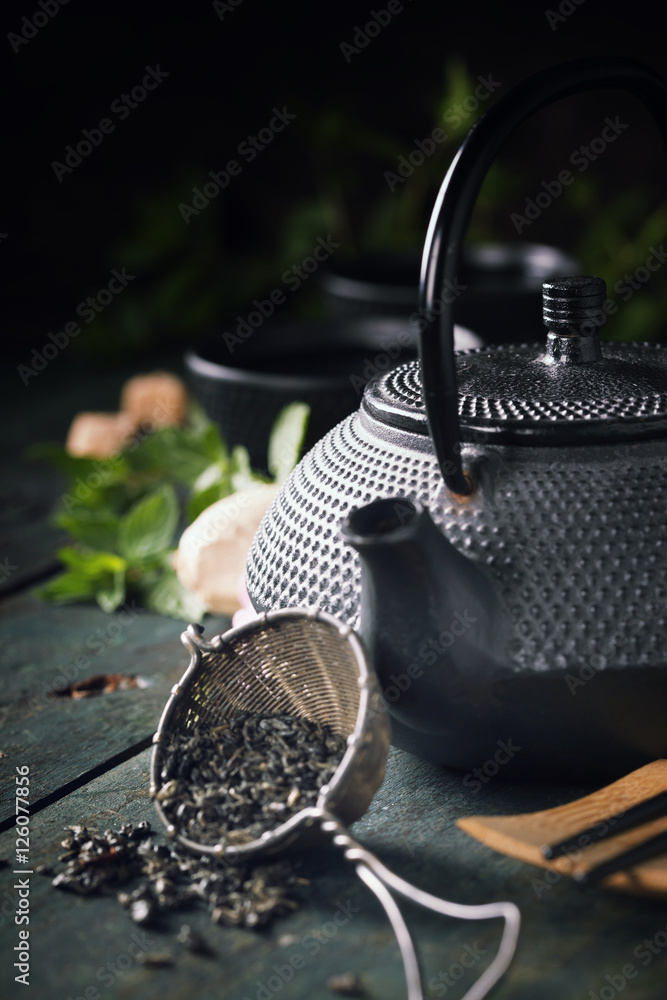 Japanese teapot and cups with mint tea