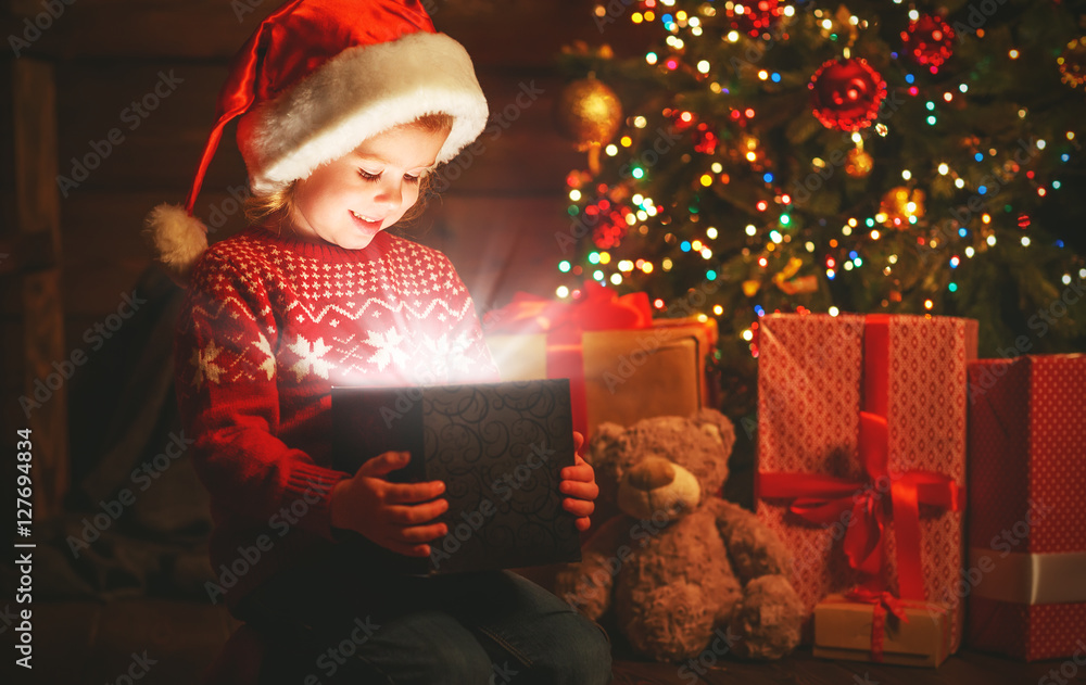 child girl with a magic Christmas gift
