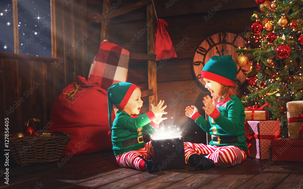happy children brother and sister elf, helper of Santa with Chri