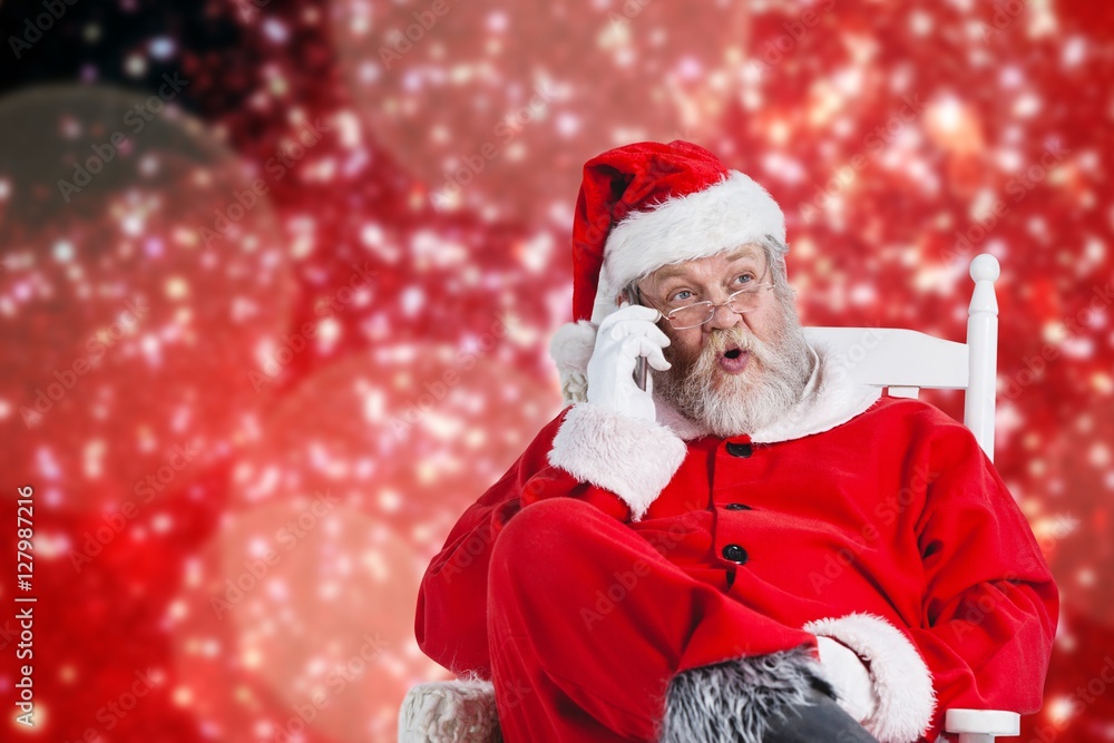 Composite image of surprised santa claus comunicating on mobile 