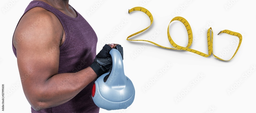Composite image of fit man exercising with kettlebell