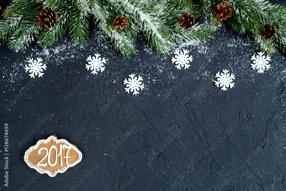 Christmas decorations, spruce branches on dark background top view