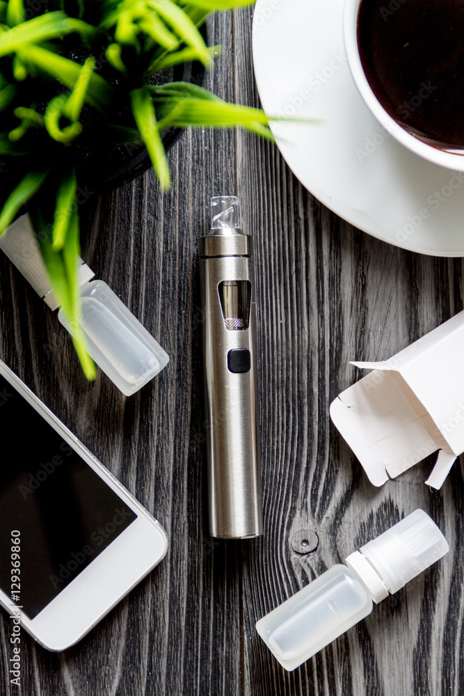 coffee, electronic cigarette, mens accessories dark wooden background top view