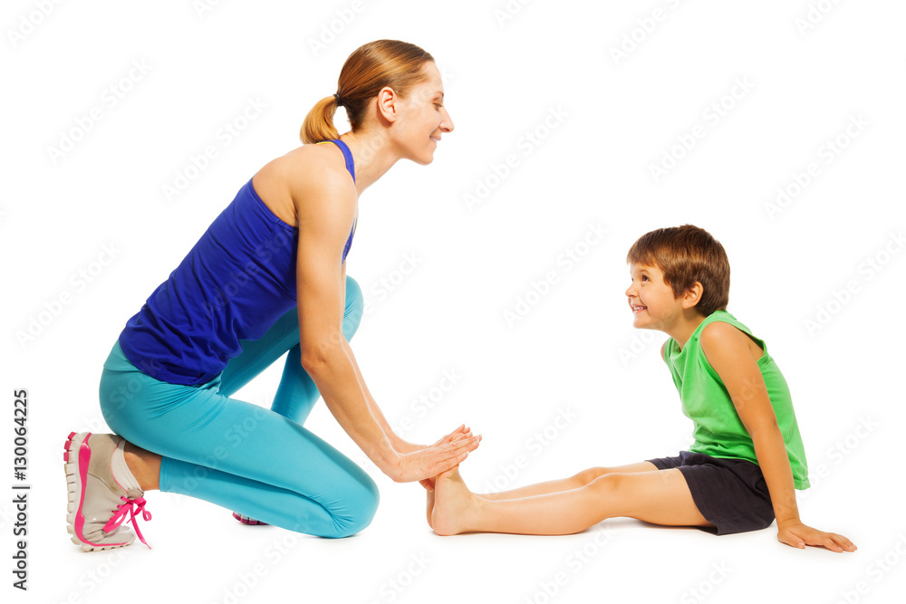 Happy boy stretching sitting on the floor with mom