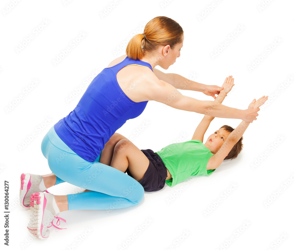 Trainer helping kid boy making breathing exercises
