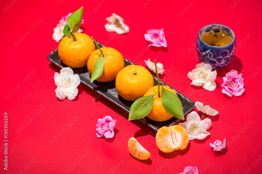 Chinese new years decoration. Mandarin orange on red background