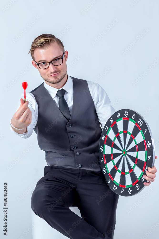 Business Man hand holding a target with darts hitting the center
