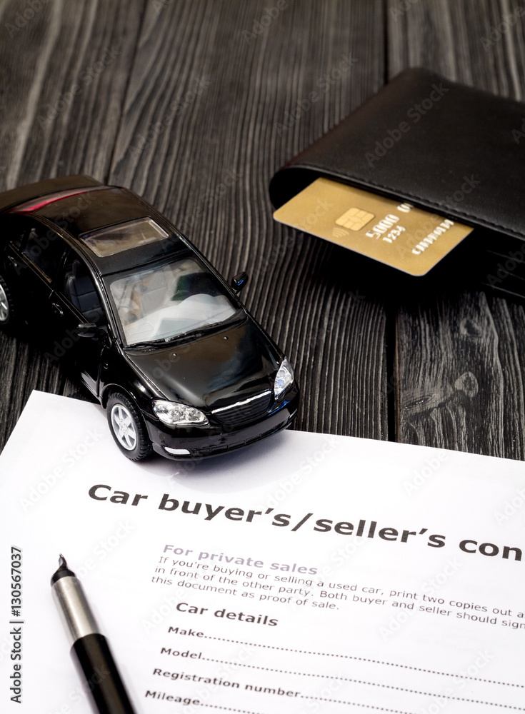 concept of buying car on dark wooden background