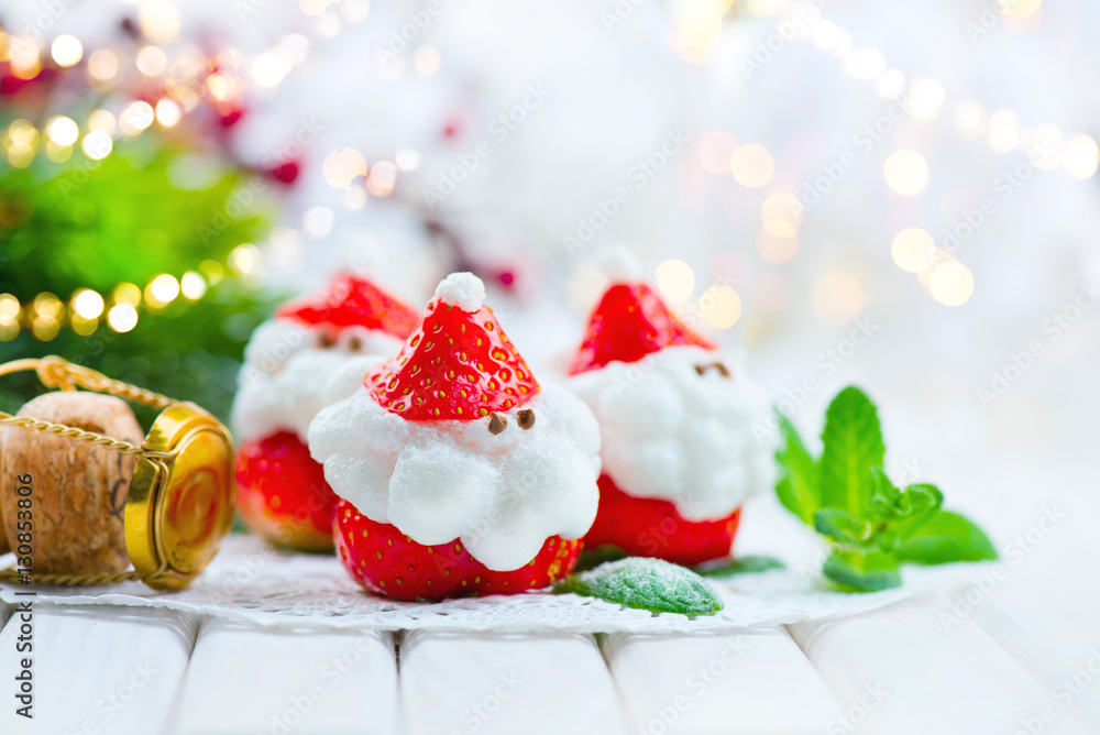 Christmas strawberry Santa. Funny dessert stuffed with whipped cream. Xmas party food idea
