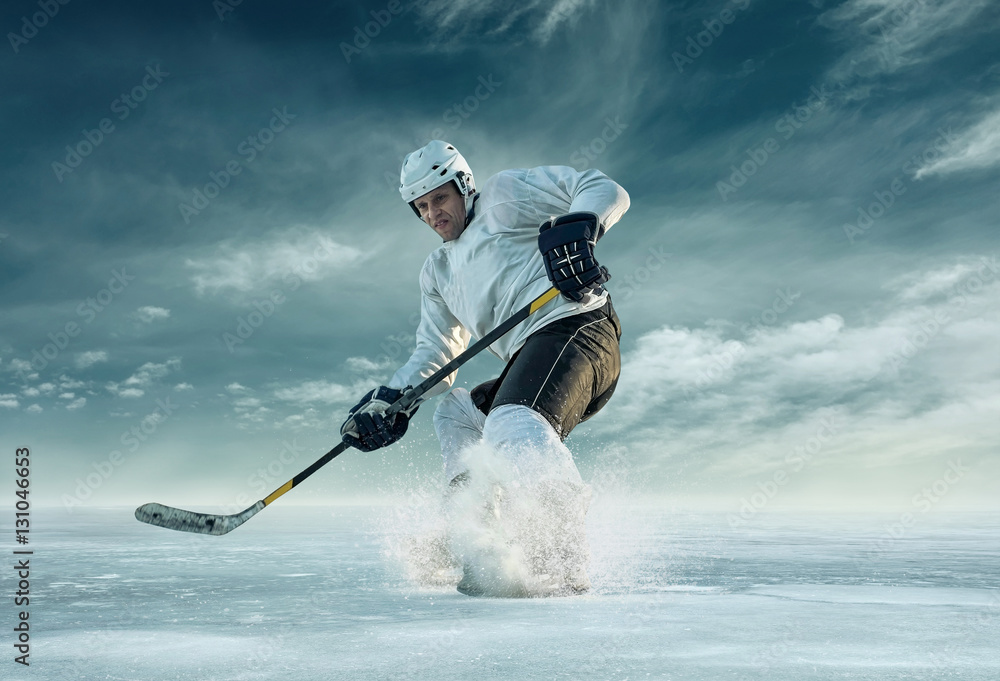Ice hockey player in action outdoor around mountains
