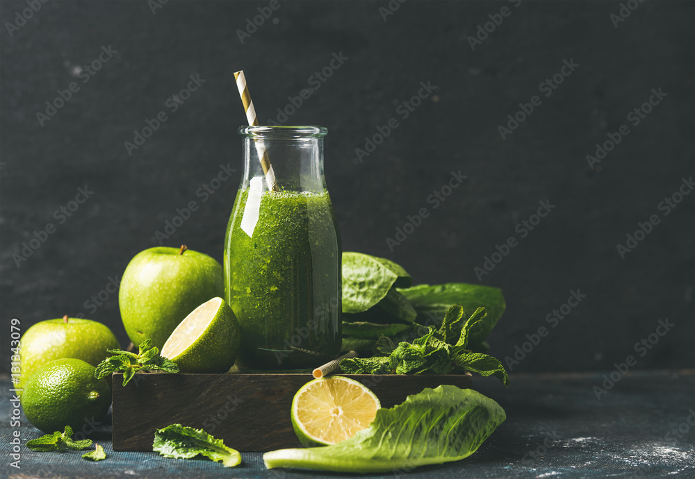Green smoothie with apple, romaine lettuce, lime and mint, dark blue background, selective focus, co