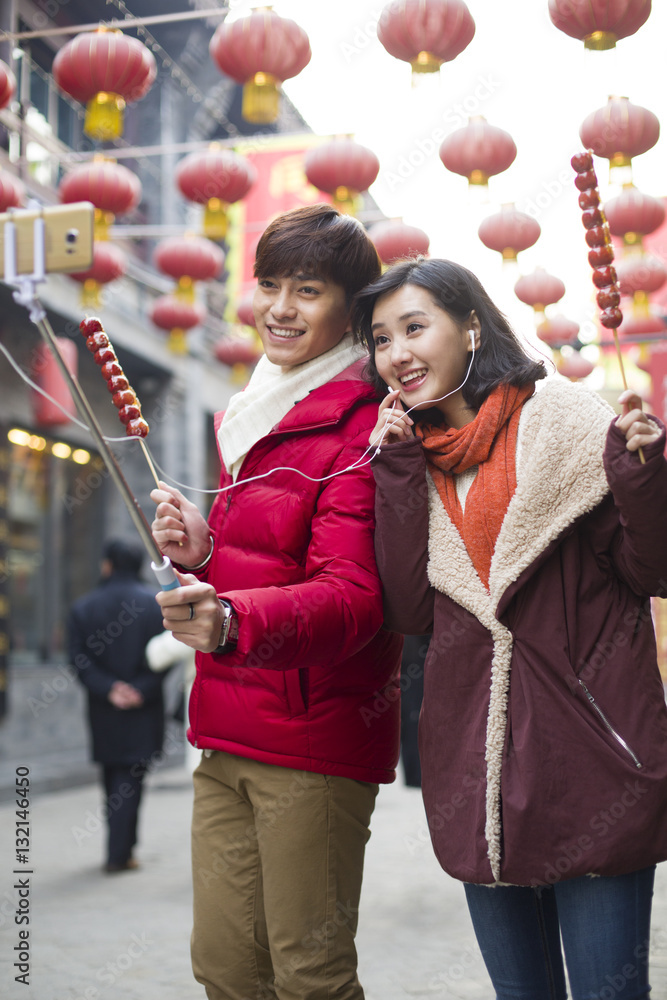 Young couple taking self portrait with a smart phone