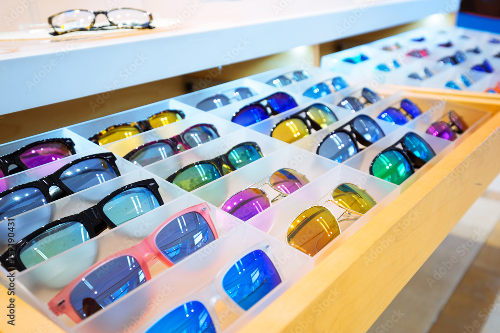 colorful sunglasses on wood shelf