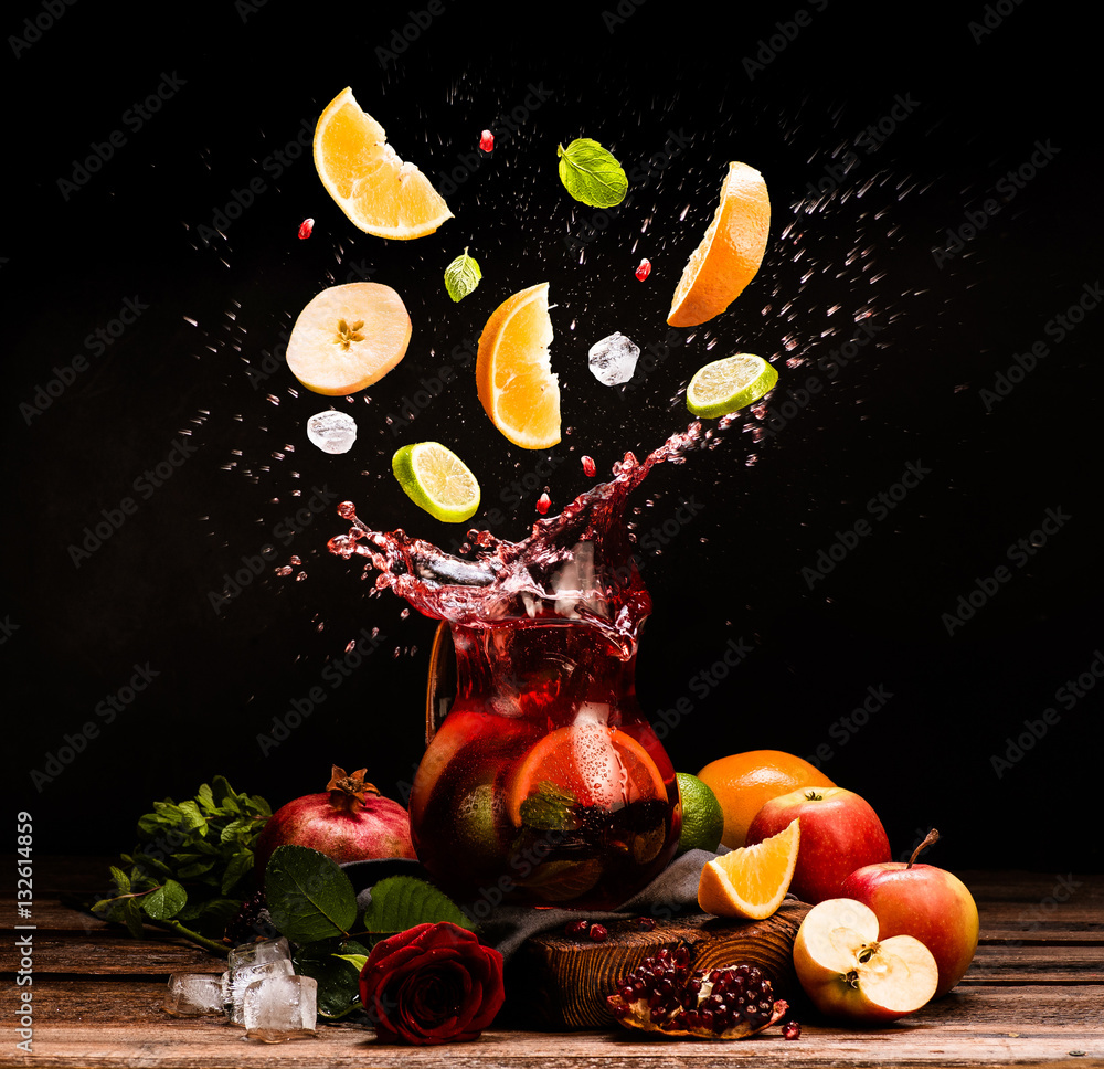 Sangria. Flying fruits. Apple, orange, lime, pomegranate, mint. Drink. Wine. Concept. Dark moody. Sp