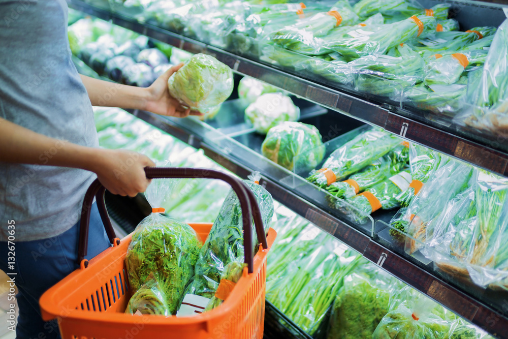 Woman are choosing vegetable in supermarket