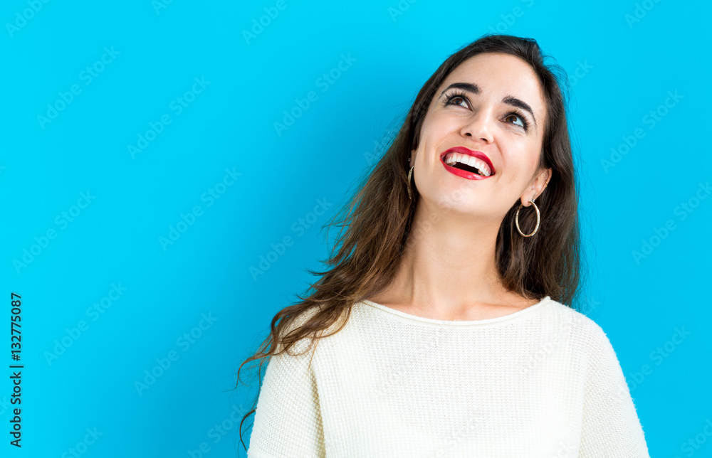 Happy young woman on a blue background