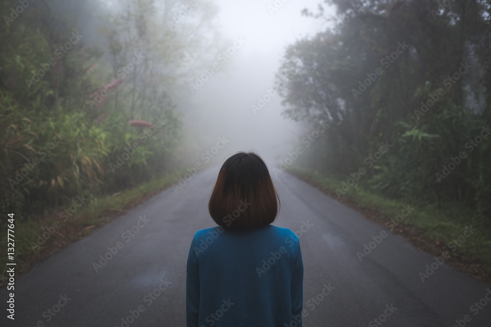 Woman on foggy road