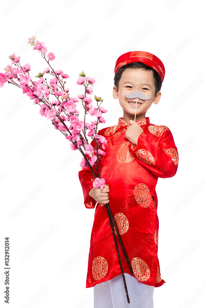 Happy Vietnamese boy in red Ao Dai celebrating New Year