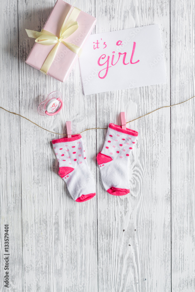birth of girl - baby shower concept on wooden background