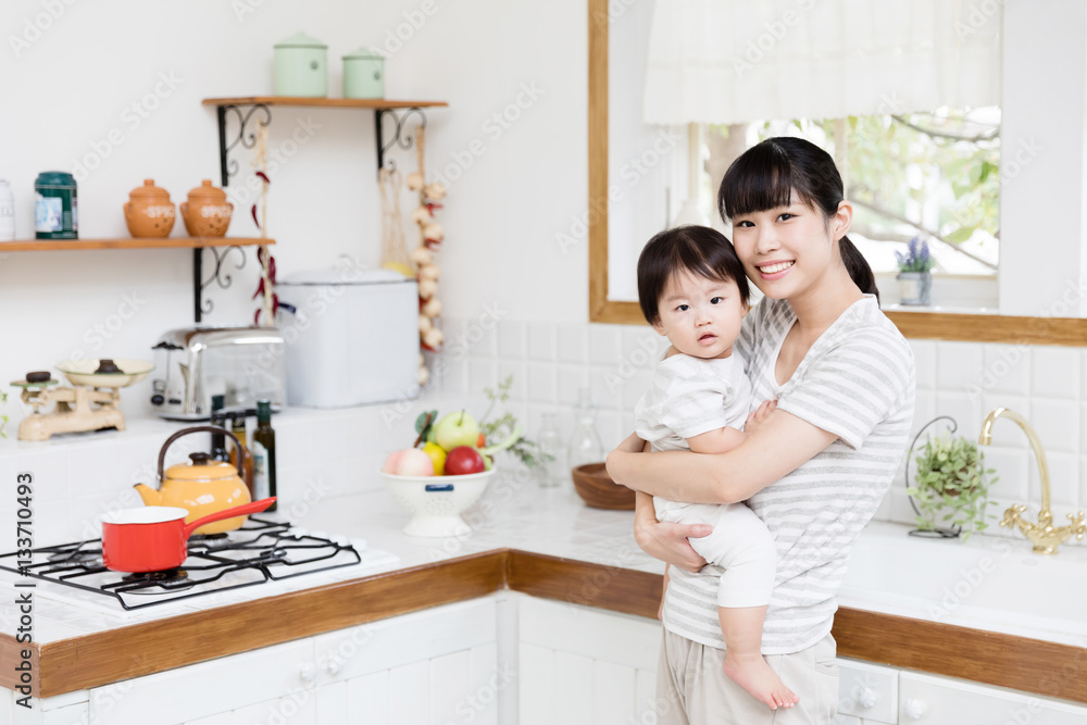 portrait of asian mother and baby in the kitchen