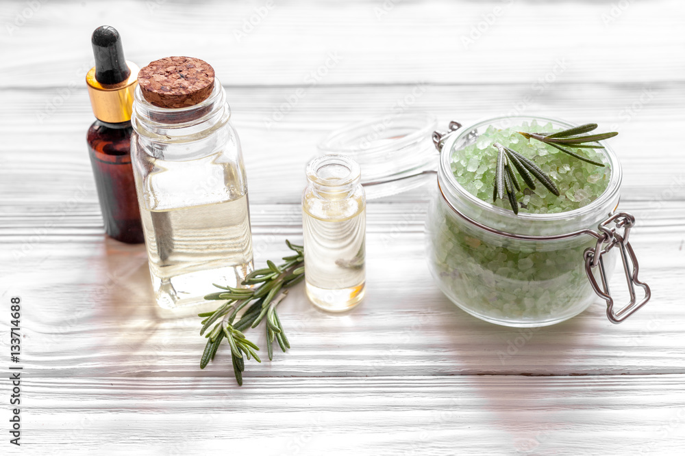 organic cosmetics with extracts of herbs rosemary on wooden background