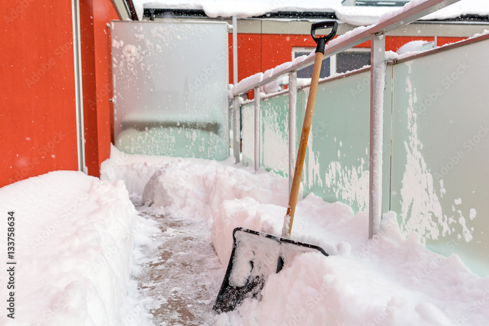 Snow shovel on the balcony after winter snowfall