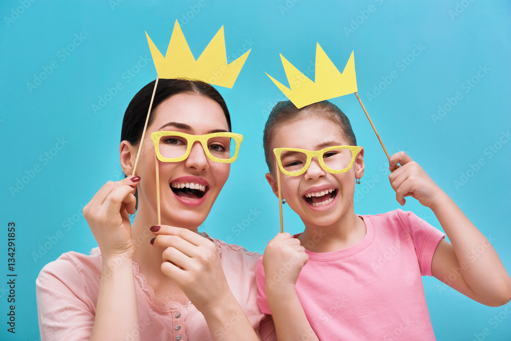 Mom and child are holding crowns
