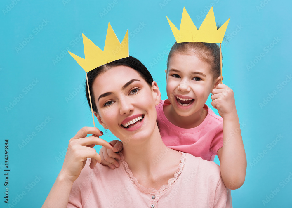 Mom and child are holding crown