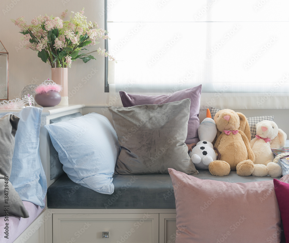 kids bedroom with dolls and set of pillows