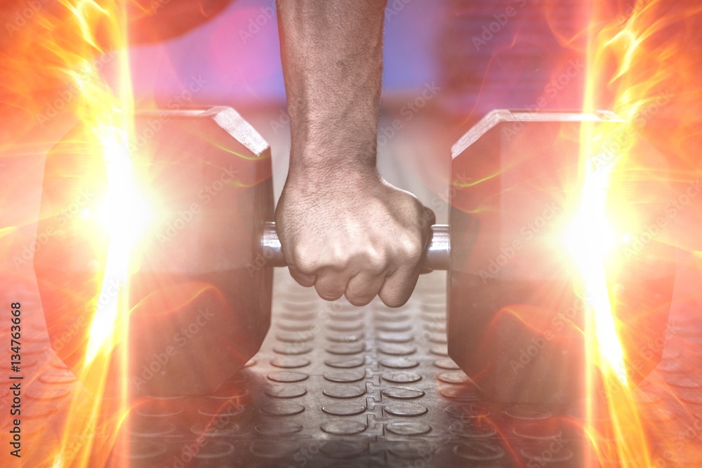 Cropped image of man holding dumbbell